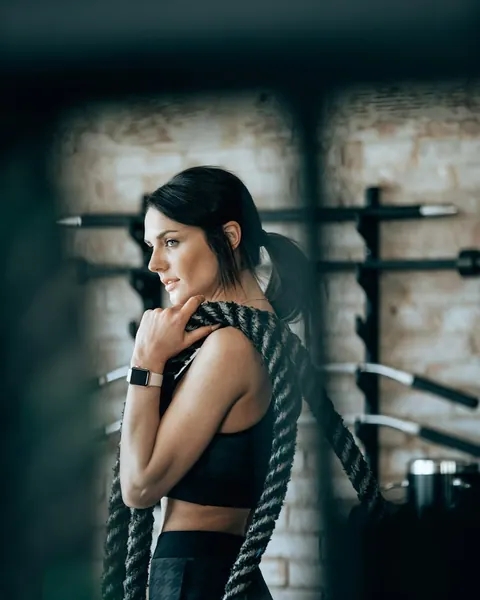 Fitness coach with battle ropes